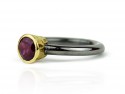 Silver ring with garnet and yellow gold.