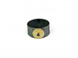 Striped oxidized silver ring with center in 750mm yellow gold and brilliant cut black diamond.