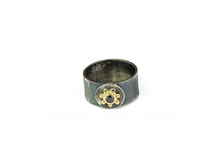 Striped oxidized silver ring with center in 750mm yellow gold and brilliant cut black diamond.