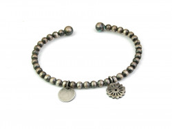 Matte rusty silver bracelet with two dangling motifs, plaque and flower. Open oval slave.