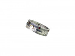 Combination of two rings of satin silver with rubies and diamonds and center of satin silver with yellow and shiny gold mouth