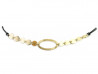 Collar formado por centro de vaga mate y placas de oro amarillo pulidas, montado con cordón de algodón negro y cierre en oro.