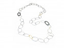 Collar llarg combinat amb vagues ovals en argent setinada i 4 vagues d'or mat i 2 peces en argent satinada.
