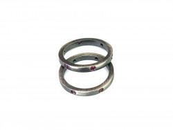 2 loose rings of satin silver with 6 rubies in each ring.