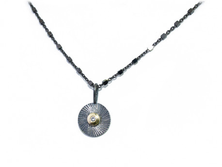 Oxidized, scratched and satin silver 925mm pendant, with central mouth in yellow gold and 1 natural brilliant of 0.02cts