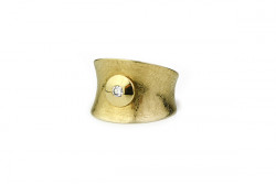 Shredded matte yellow gold ring and a brilliant center on a wide round glossy mouth.