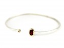 Slave silver bracelet with garnet mouths and bright yellow gold.