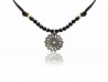 Silk necklace with onyx beads and silver flower pendant.