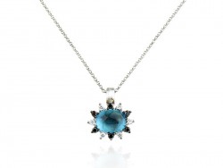 Gold pendant with blue topaz, bright whites and blacks.