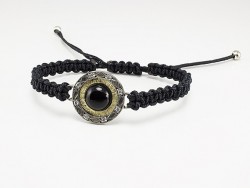 Macrame bracelet with silver center, yellow gold white diamonds and onyx.